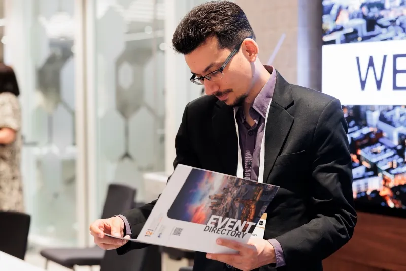 Attendee reviewing the 121 Mining Investment event directory